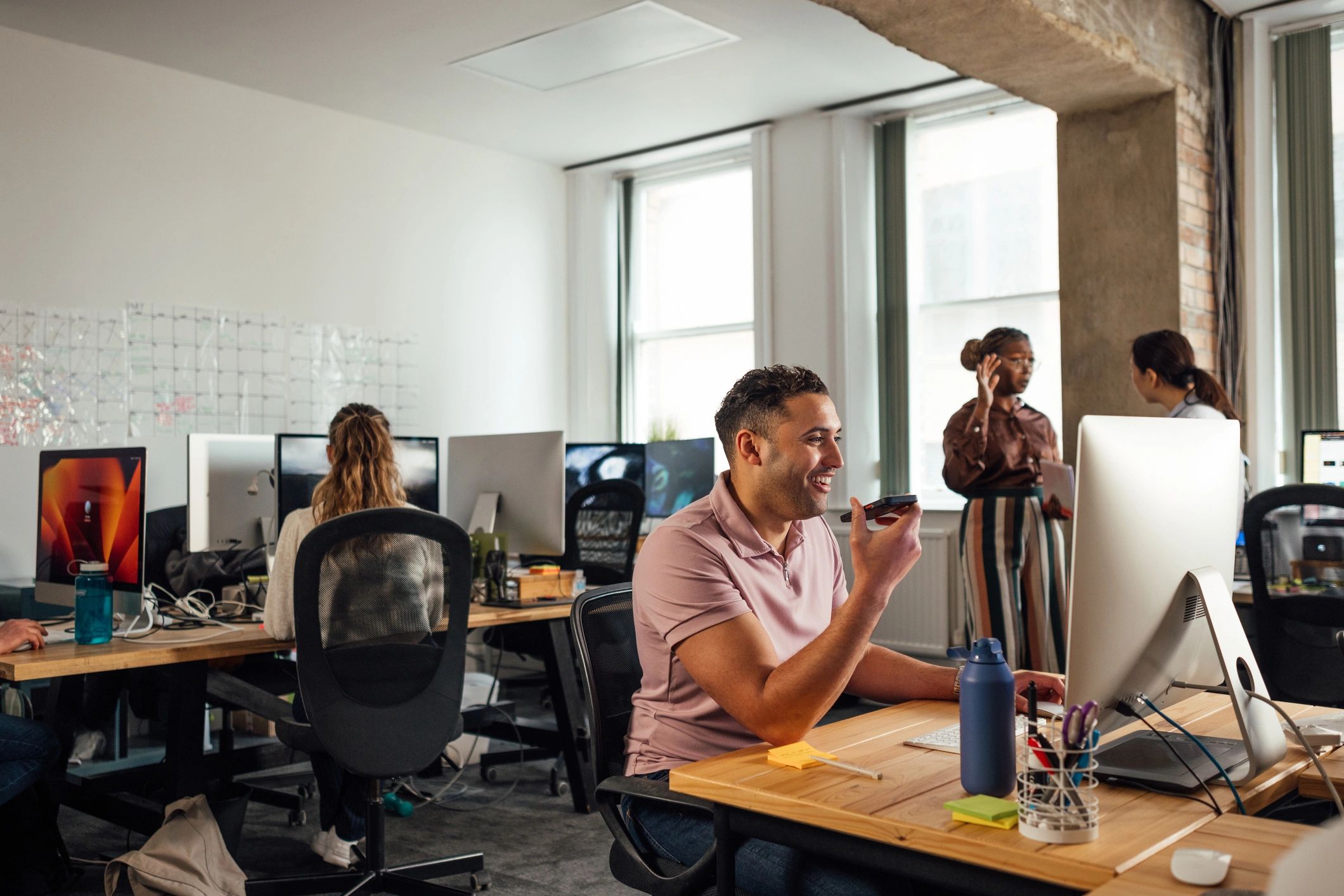 Business team using computers and digital devices in an office
