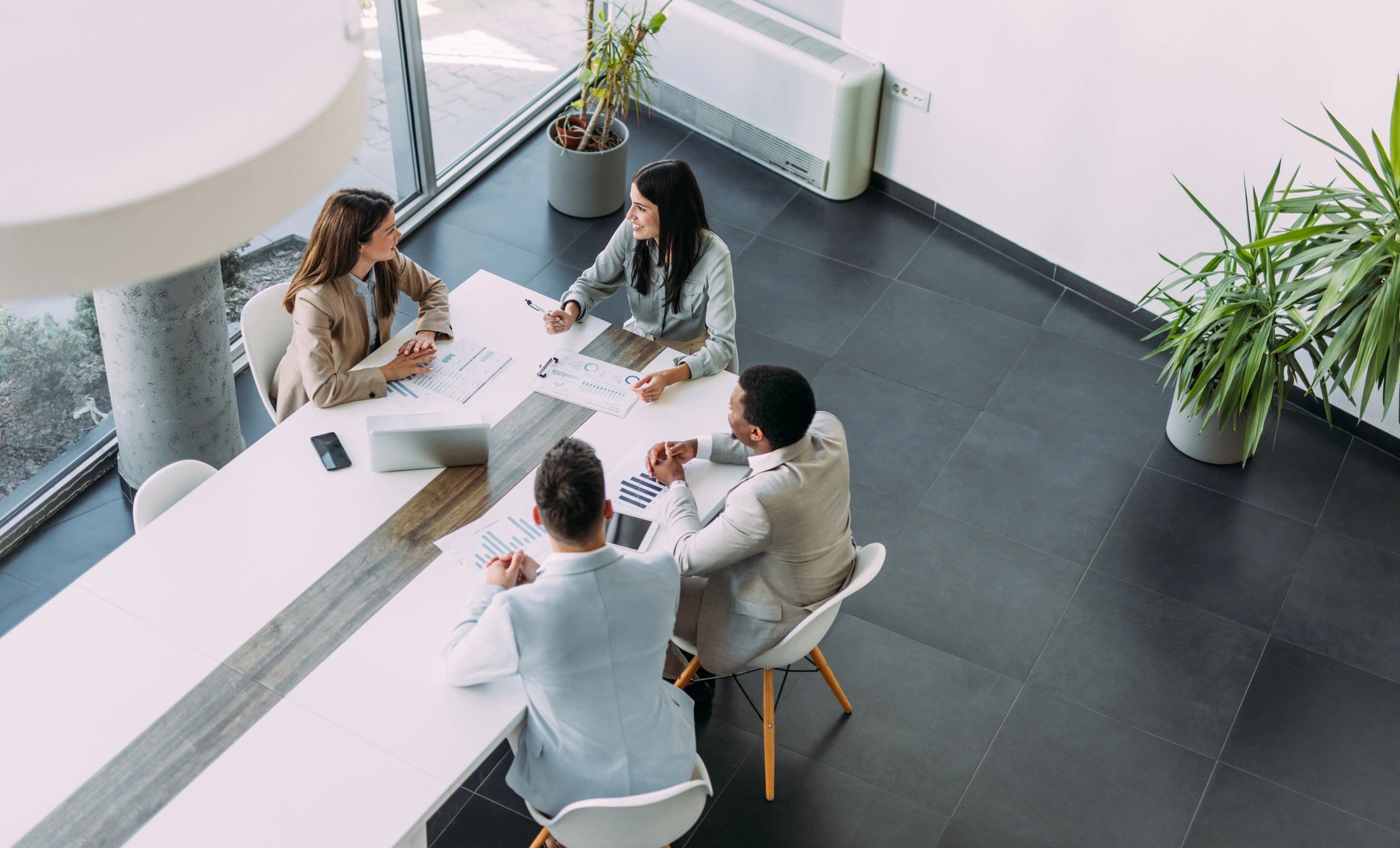 Business team meeting around digital technology solutions