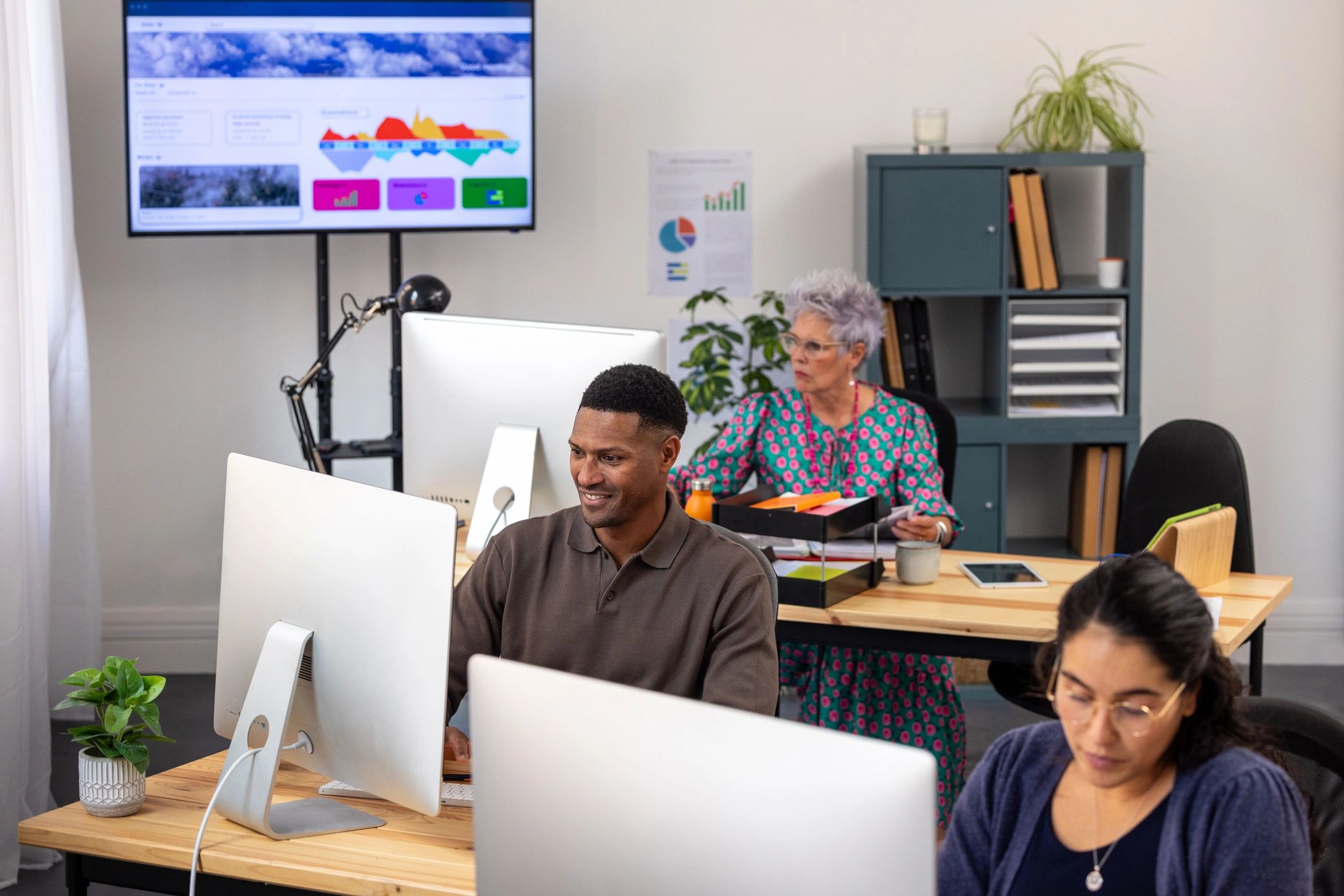 Modern office team working with computers and digital displays