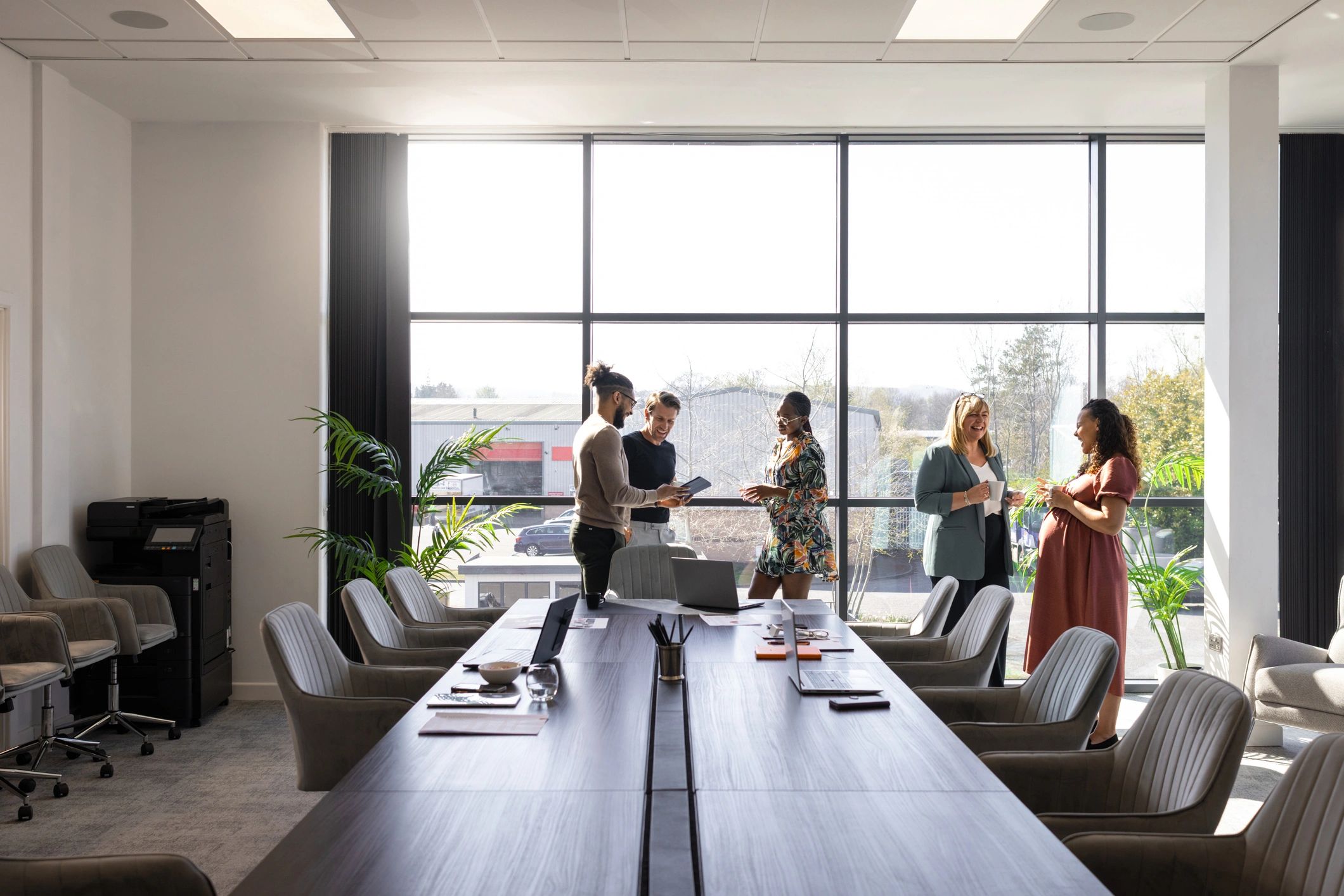 Business colleagues discussing digital solutions in a modern office