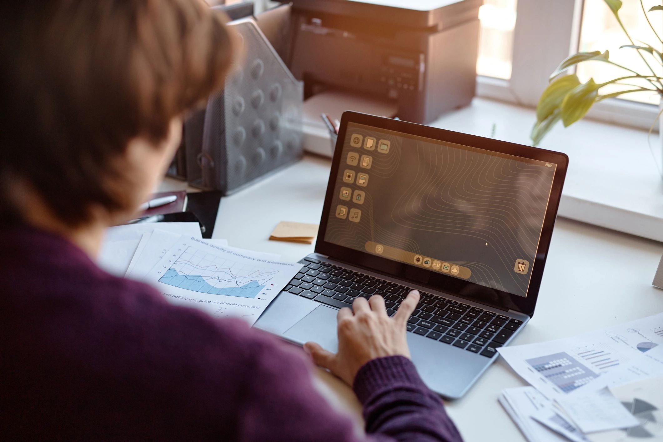 Professional reviewing business data on a laptop for invoicing operations